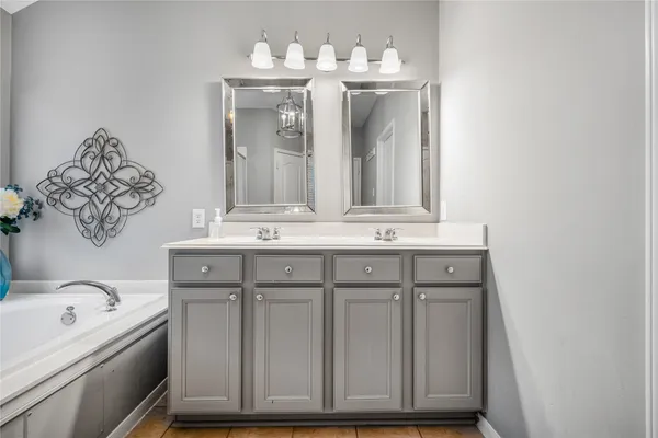 a bathroom with a sink vanity and mirror