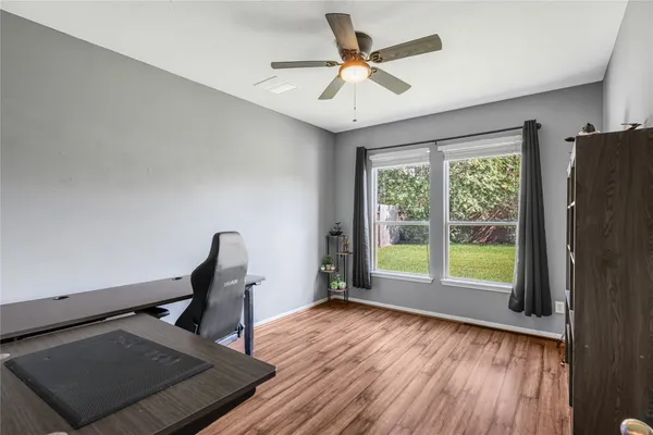 a view of room with window and wooden floor