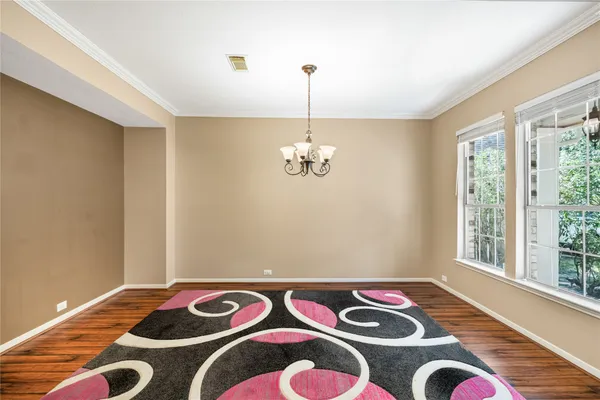a bedroom with a bed and a wooden floor