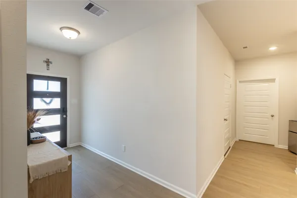 wooden floor in an empty room and a bathroom