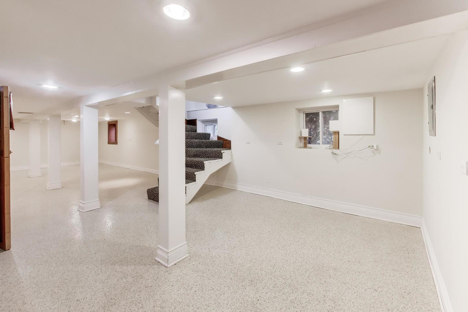256 Blackhawk Road Riverside, IL 60546 - Photo 40 of 73 an empty room with wooden floor and windows