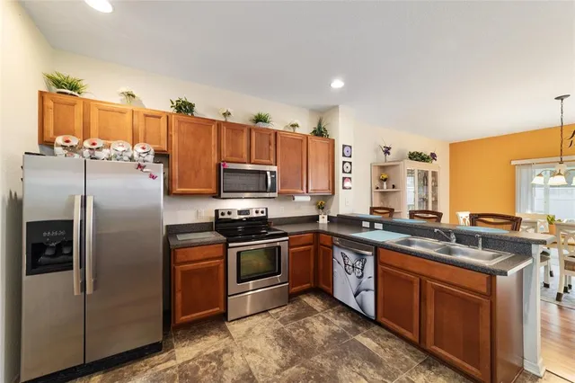 a dining room with furniture a chandelier and wooden floor