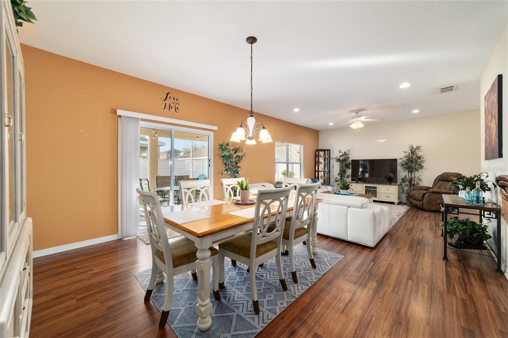 12312 Northeast 48th Loop Oxford, FL 34484 - Photo 13 of 54 a view of a dining room with furniture window and wooden floor