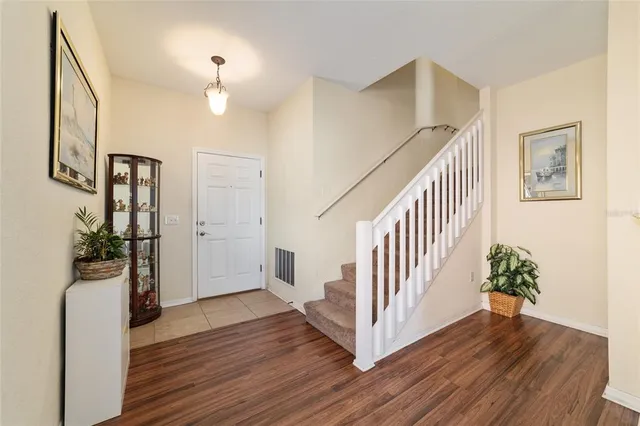 a bedroom with a bed and a chandelier fan