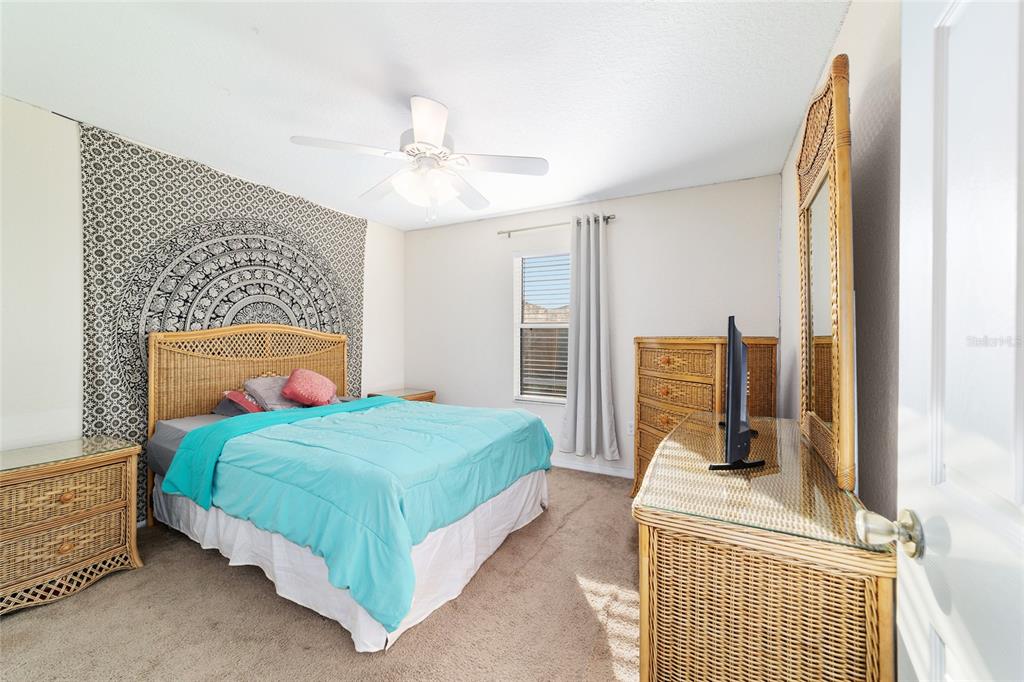 12312 Northeast 48th Loop Oxford, FL 34484 - Photo 20 of 54 a bedroom with a bed and wooden floor