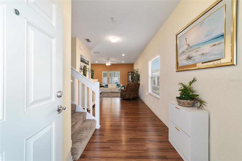 12312 Northeast 48th Loop Oxford, FL 34484 - Photo 26 of 54 a hallway with wooden floor windows and stairs
