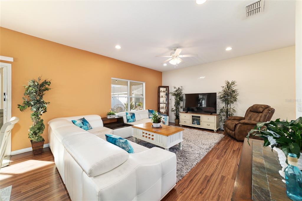 12312 Northeast 48th Loop Oxford, FL 34484 - Photo 28 of 54 a living room with furniture and a flat screen tv