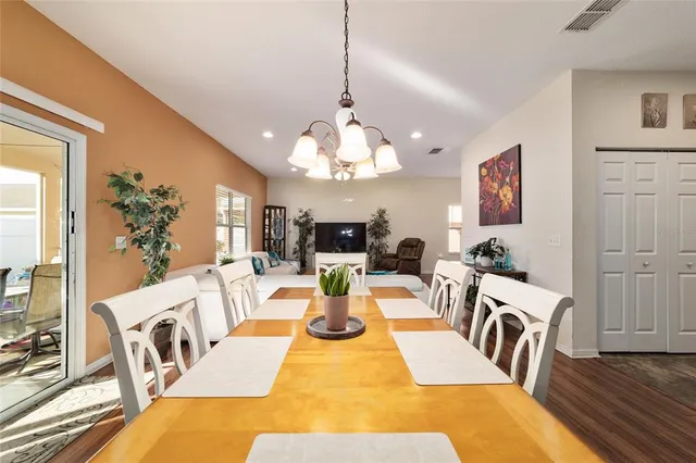 a dining room with furniture and wooden floor