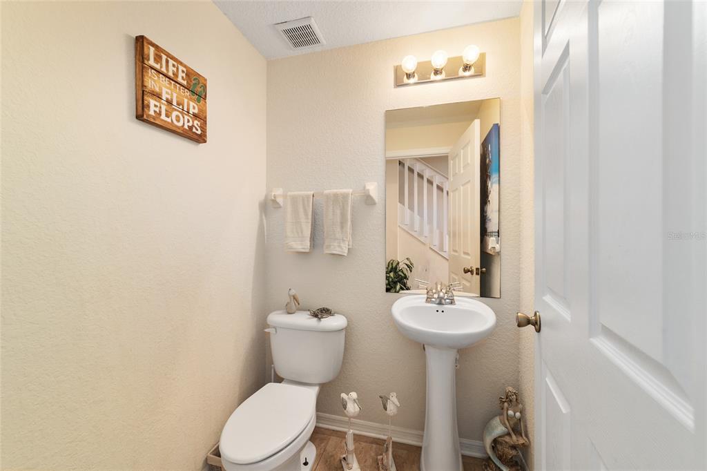 12312 Northeast 48th Loop Oxford, FL 34484 - Photo 39 of 54 a bathroom with a toilet a sink and mirror