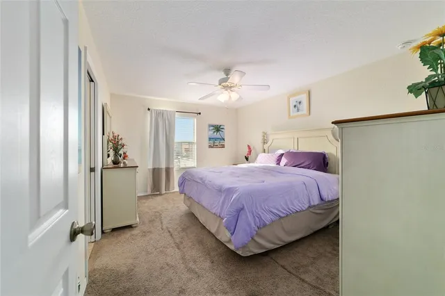 a bedroom with a bed and a potted plant