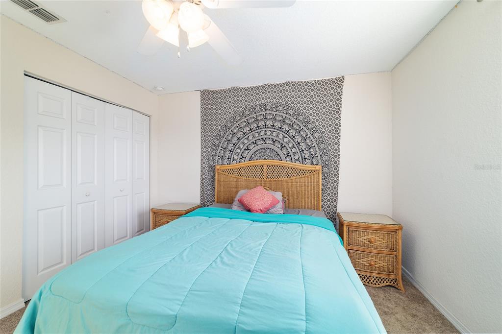 12312 Northeast 48th Loop Oxford, FL 34484 - Photo 44 of 54 a bedroom with a bed and a potted plant