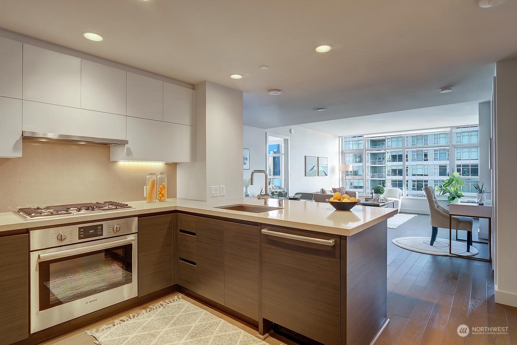 583 Battery Street, Unit 2708N Seattle, WA 98121 - Photo 12 of 30 a kitchen with a sink stove and cabinets