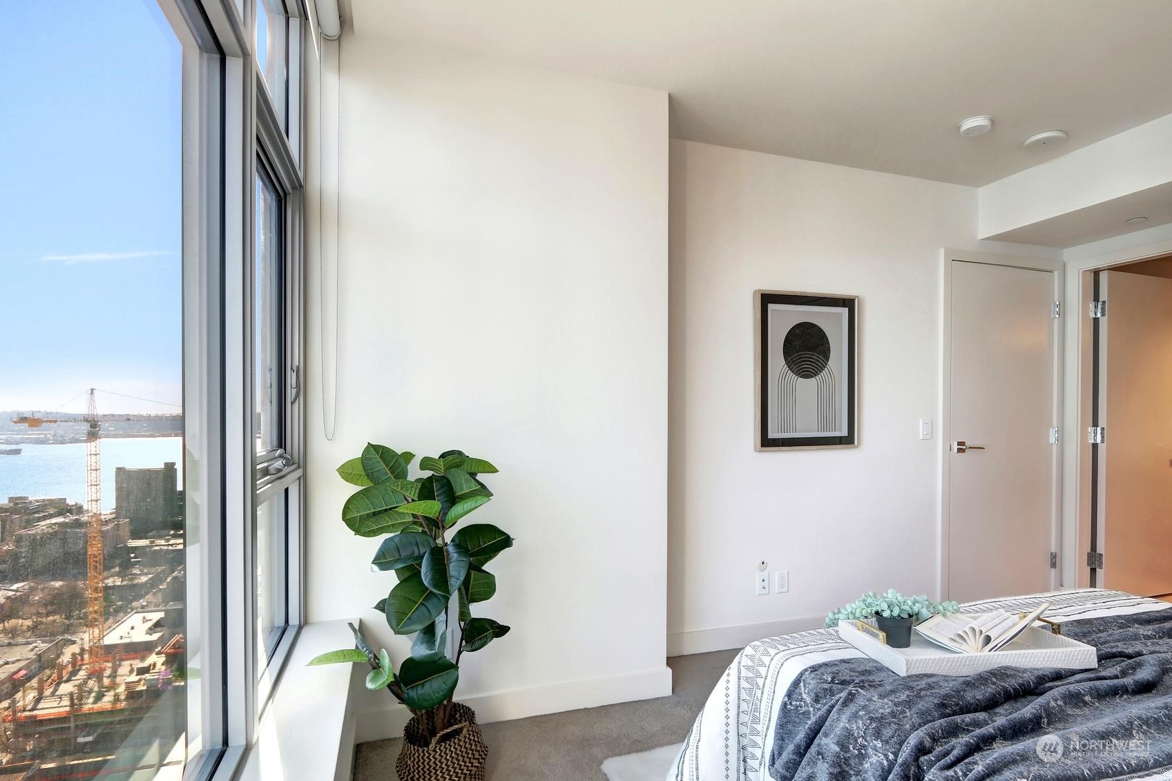 583 Battery Street, Unit 2708N Seattle, WA 98121 - Photo 16 of 30 a bedroom with a bed and a potted plant