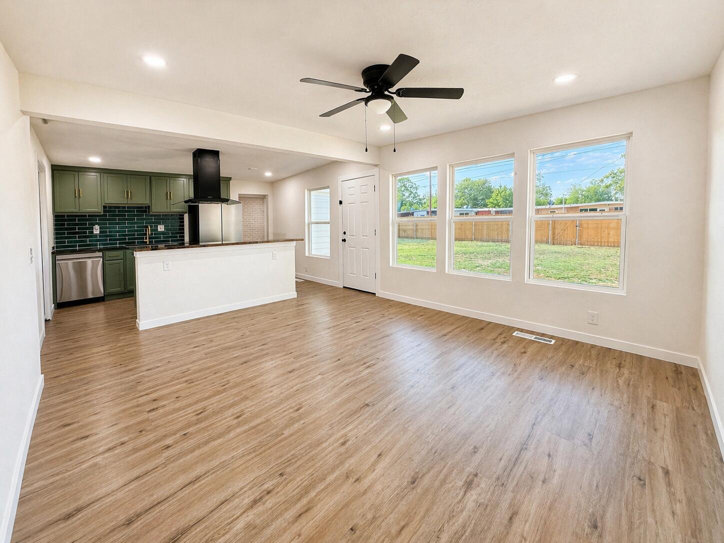 2316 48th Street Lubbock, TX 79412 - Photo 3 of 18 a view of an empty room with wooden floor and a window