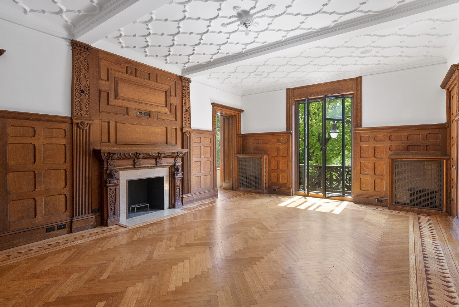 a view of an empty room with a fireplace and a window