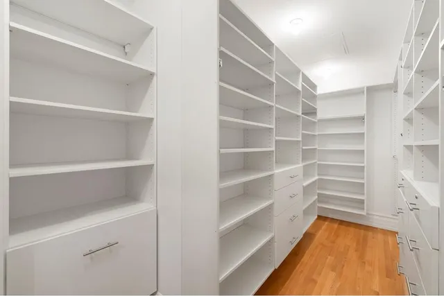 a bathroom with a granite countertop sink a toilet a mirror and shower