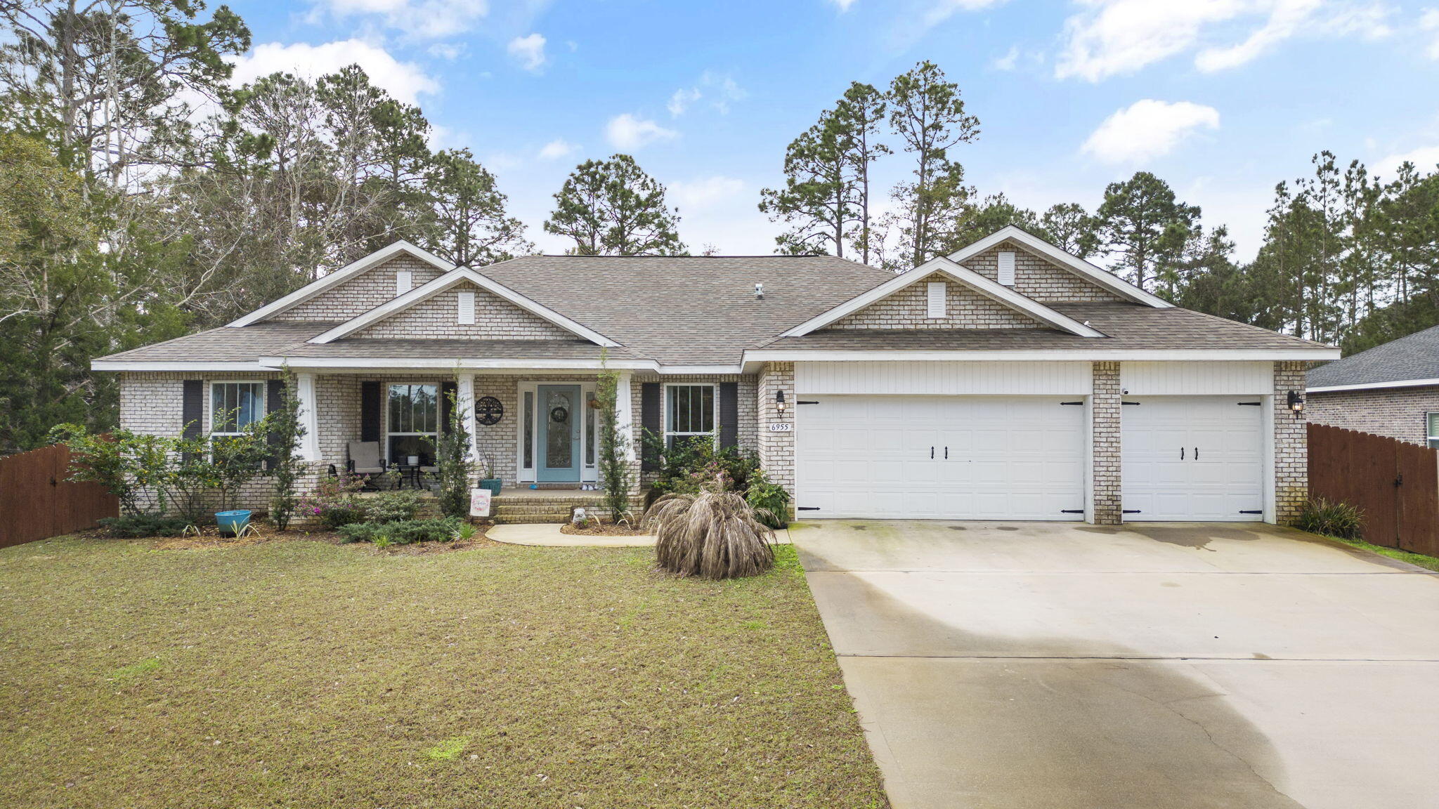 6955 Snug Waters Road Navarre, FL 32566 - Photo 1 of 45 a view of a house with sitting area and garden