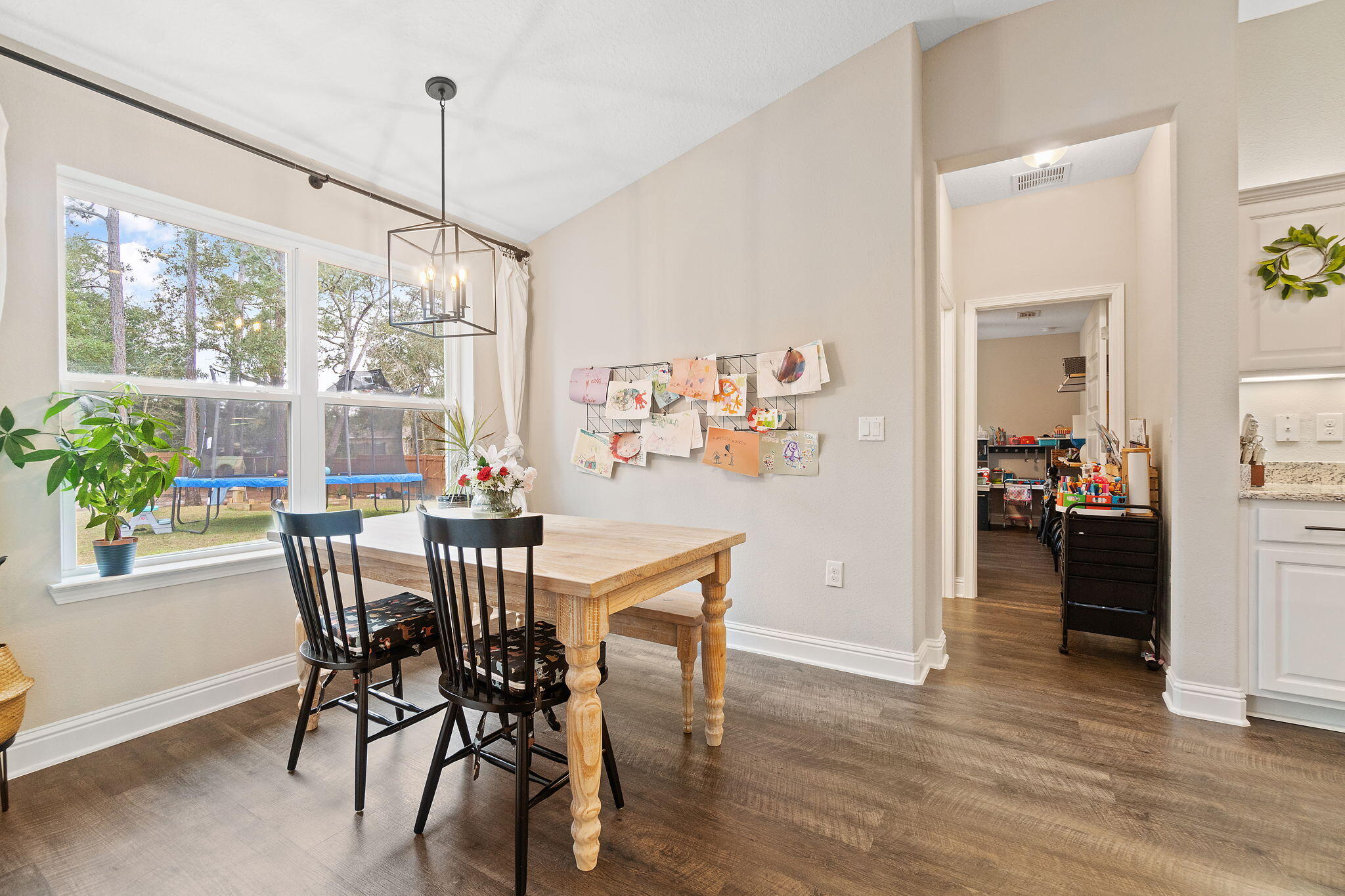 6955 Snug Waters Road Navarre, FL 32566 - Photo 20 of 45 a view of a dining room with furniture window and wooden floor