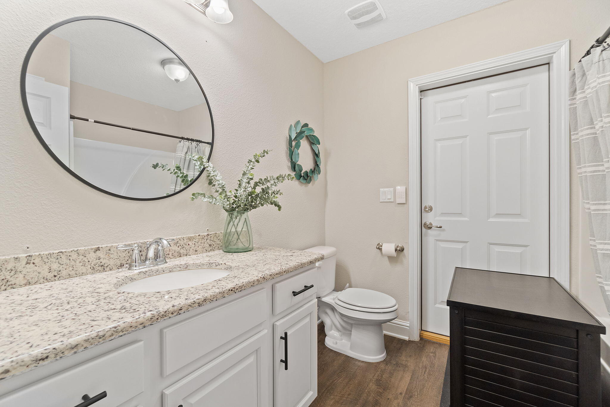 6955 Snug Waters Road Navarre, FL 32566 - Photo 21 of 45 a bathroom with a granite countertop sink a toilet and a mirror