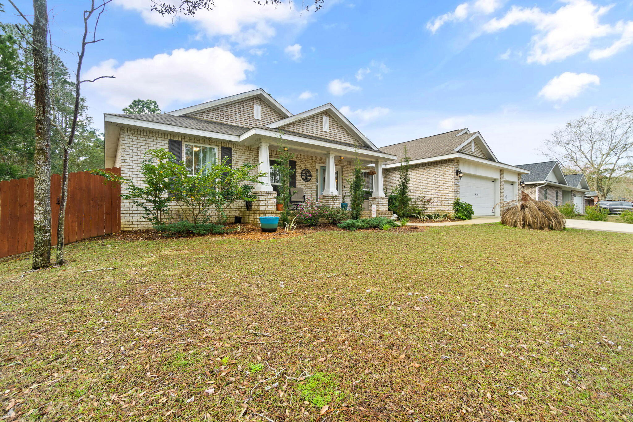 6955 Snug Waters Road Navarre, FL 32566 - Photo 3 of 45 a front view of a house with a yard