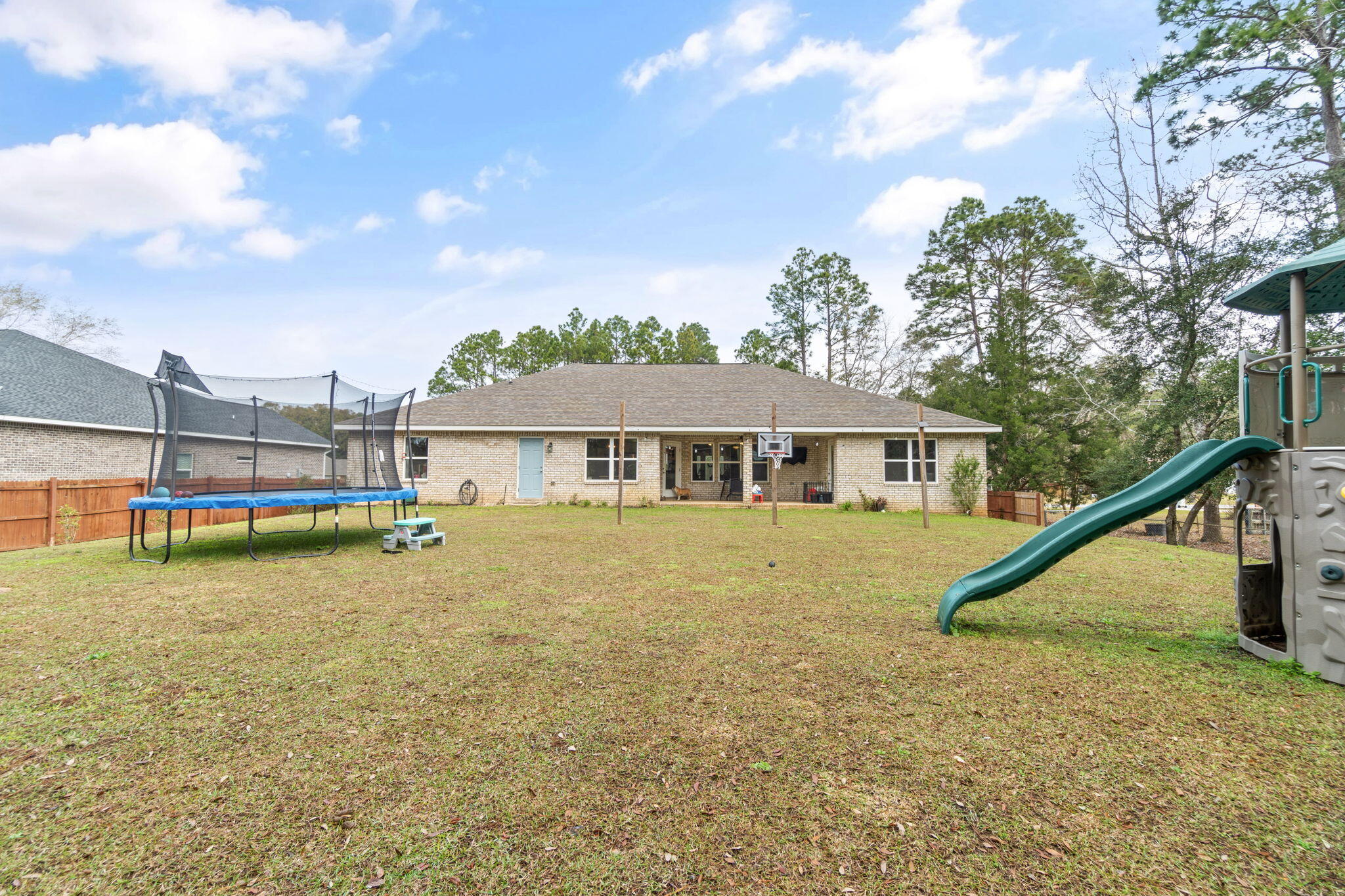 6955 Snug Waters Road Navarre, FL 32566 - Photo 40 of 45 a view of a house with a yard