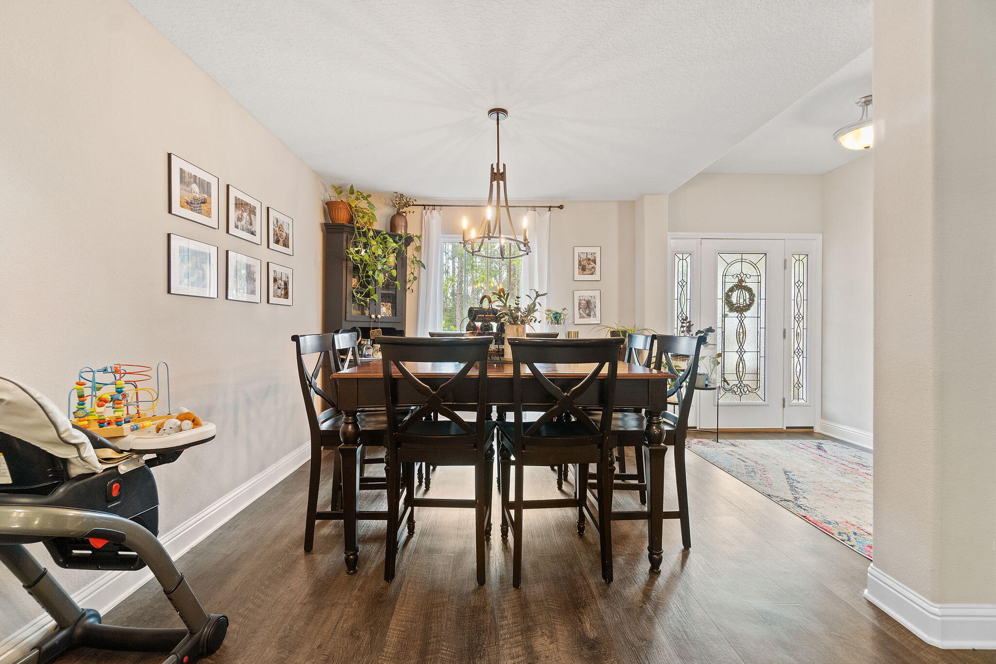 6955 Snug Waters Road Navarre, FL 32566 - Photo 8 of 45 a view of a dining room with furniture window and wooden floor