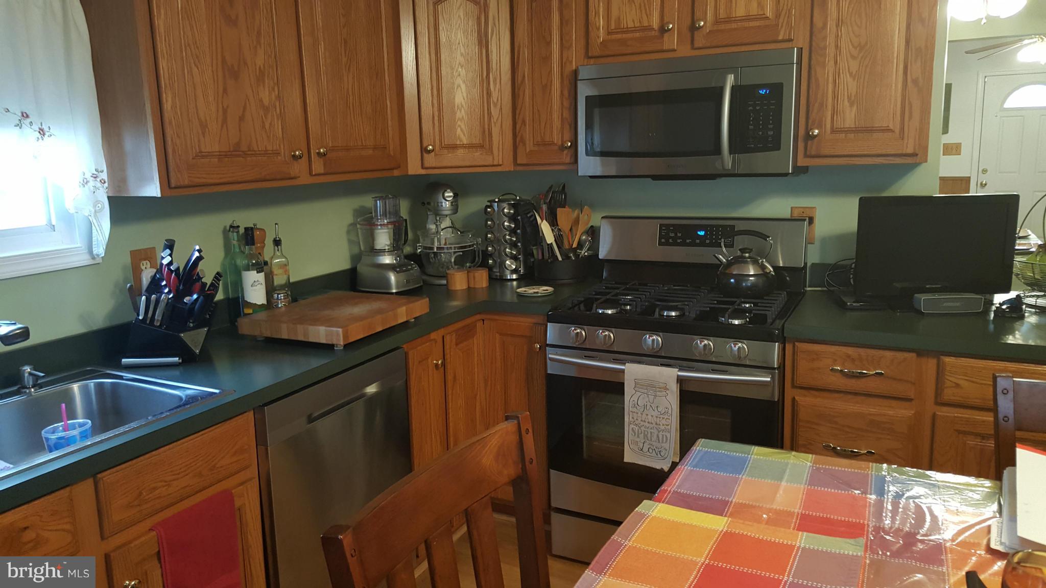 8250 Longpoint Road Baltimore, MD 21222 - Photo 2 of 30 a kitchen with stainless steel appliances granite countertop a sink stove and cabinets