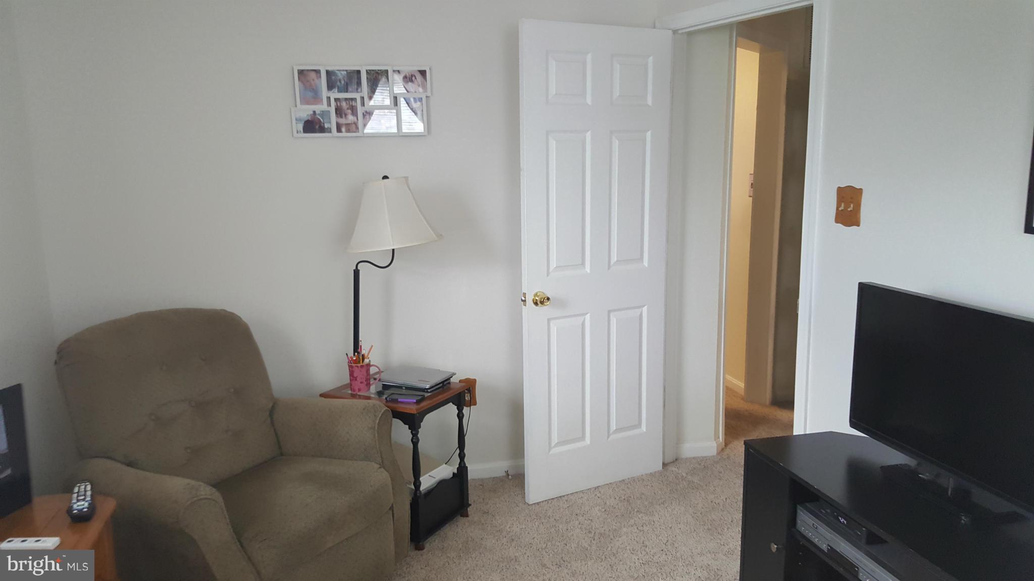 8250 Longpoint Road Baltimore, MD 21222 - Photo 11 of 30 a living room with furniture and a flat screen tv