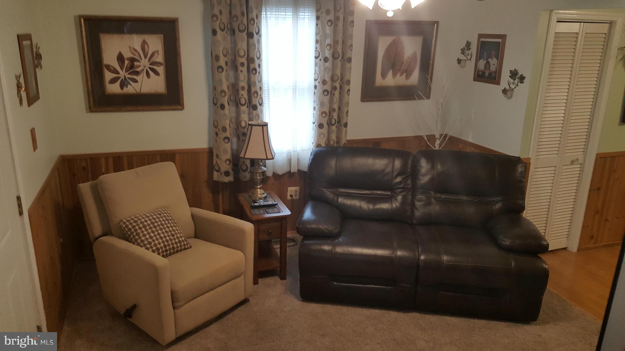 8250 Longpoint Road Baltimore, MD 21222 - Photo 12 of 30 a living room with furniture and a window