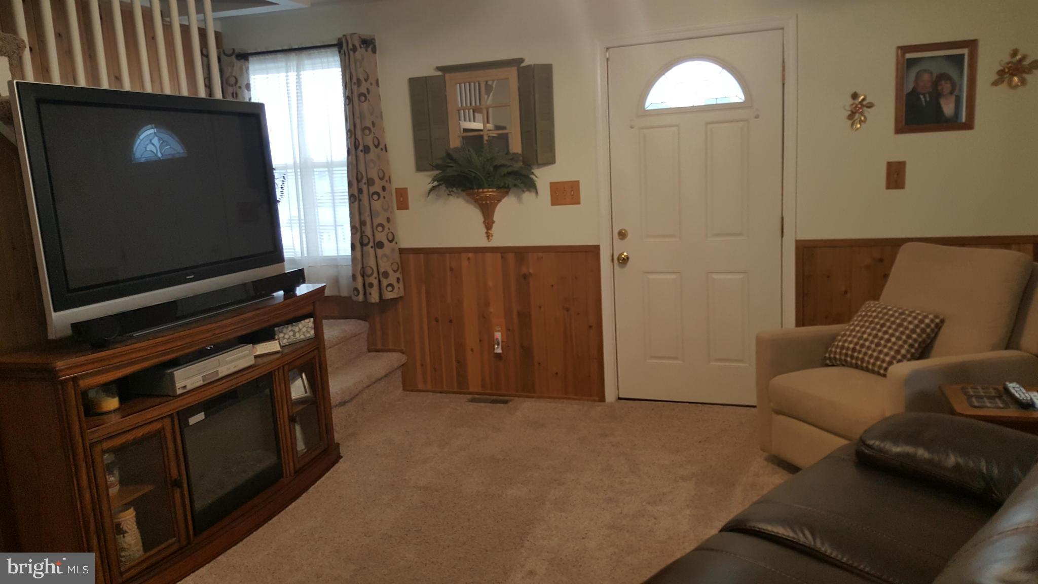 8250 Longpoint Road Baltimore, MD 21222 - Photo 14 of 30 a living room with furniture and a flat screen tv