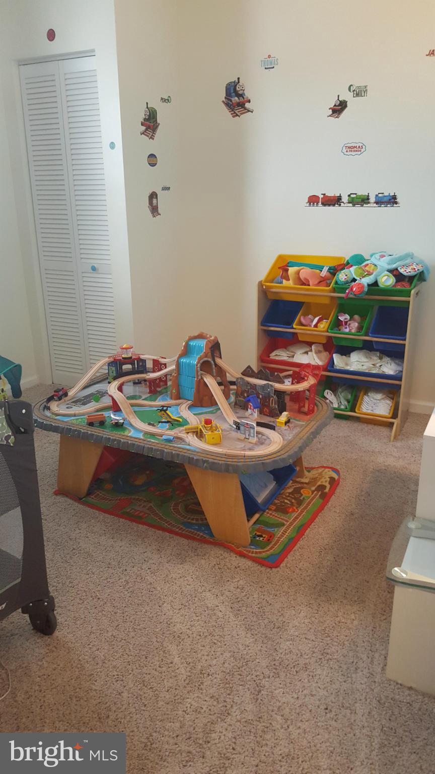8250 Longpoint Road Baltimore, MD 21222 - Photo 21 of 30 a bedroom with toys and wooden floor
