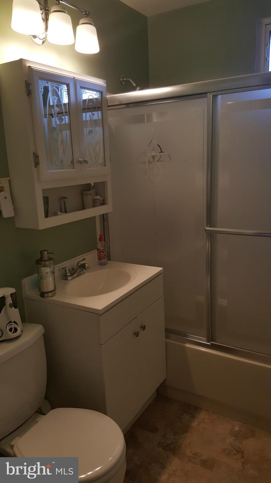 8250 Longpoint Road Baltimore, MD 21222 - Photo 22 of 30 a bathroom with a sink a toilet and shower