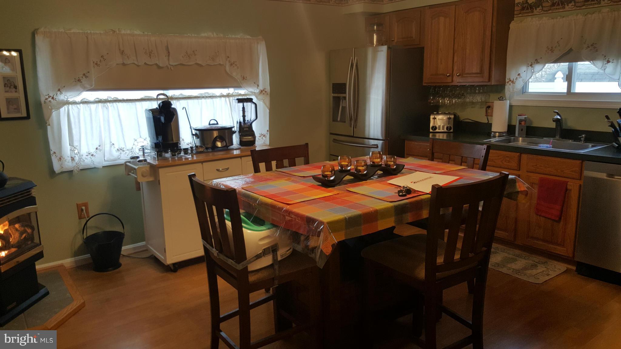 8250 Longpoint Road Baltimore, MD 21222 - Photo 4 of 30 a dining table with chairs and window