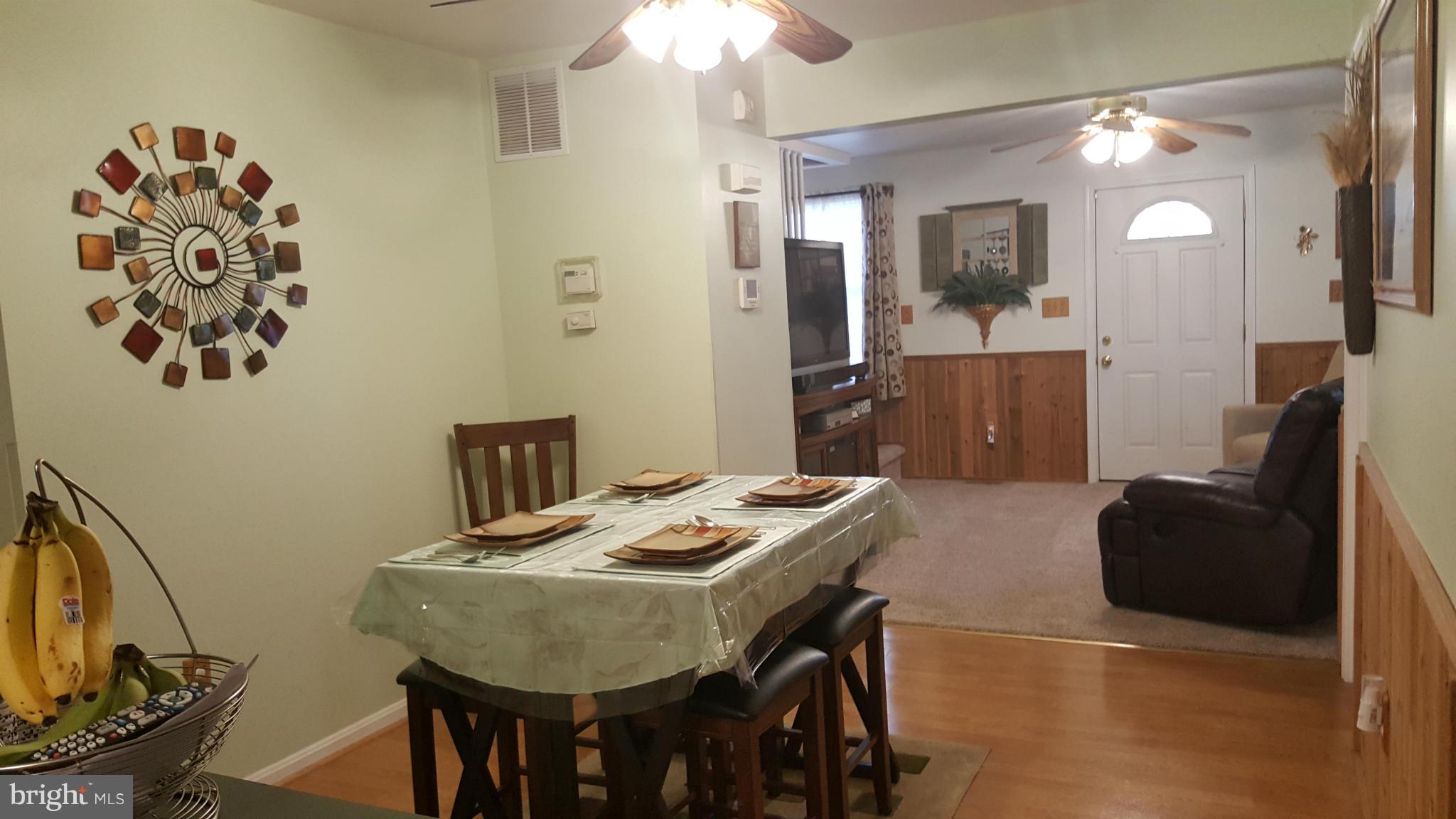 8250 Longpoint Road Baltimore, MD 21222 - Photo 6 of 30 a view of a dining room with furniture and wooden floor