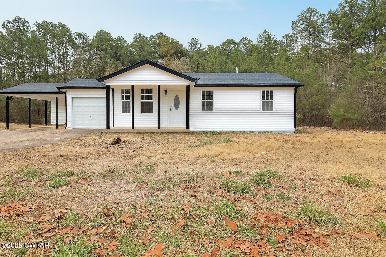 2555 Old Finger Road Finger, TN 38334 - Photo 2 of 13 a front of a house with a garden