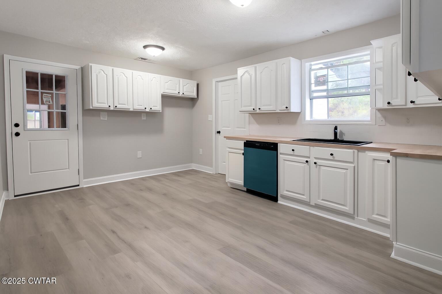 2555 Old Finger Road Finger, TN 38334 - Photo 5 of 13 a kitchen with granite countertop a sink cabinets and wooden floor