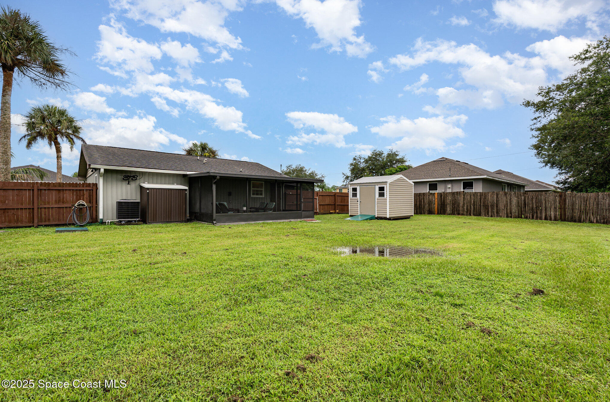 1095 Dorchester Road Palm Bay, FL 32907 - Photo 25 of 26 a front view of a house with a garden