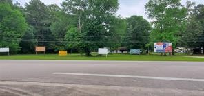 a green field with trees in front of it