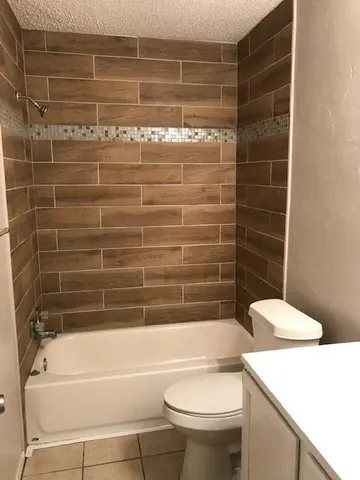 a bathroom with a toilet and a bath tub