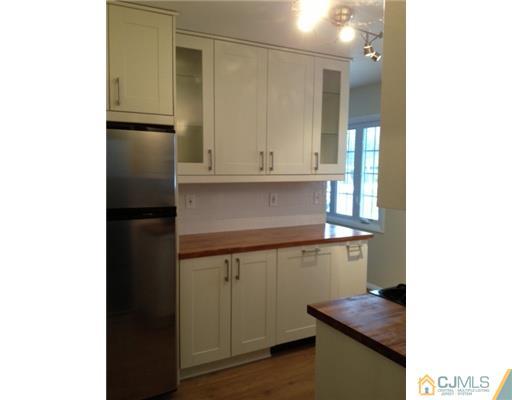 82 Princeton Road Old Bridge, NJ 08859 - Photo 4 of 6 a kitchen with a refrigerator and cabinets