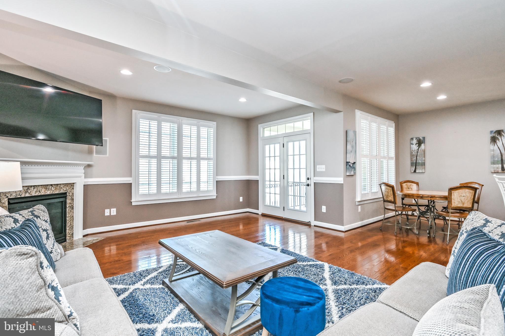 24947 Earlsford Drive Chantilly, VA 20152 - Photo 14 of 40 a living room with furniture a flat screen tv and a floor to ceiling window