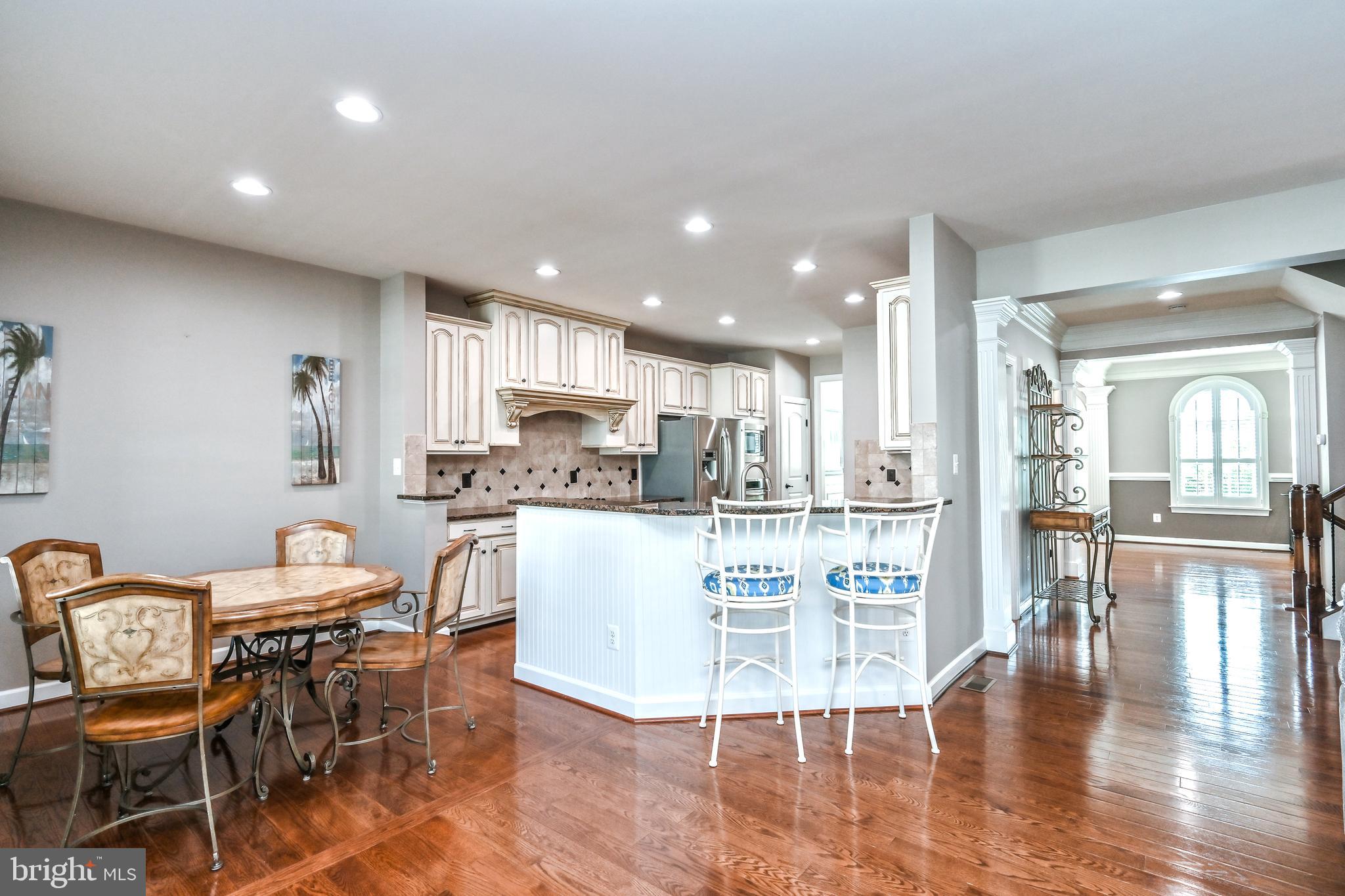 24947 Earlsford Drive Chantilly, VA 20152 - Photo 17 of 40 a dining hall with stainless steel appliances granite countertop a dining table chairs and granite counter tops