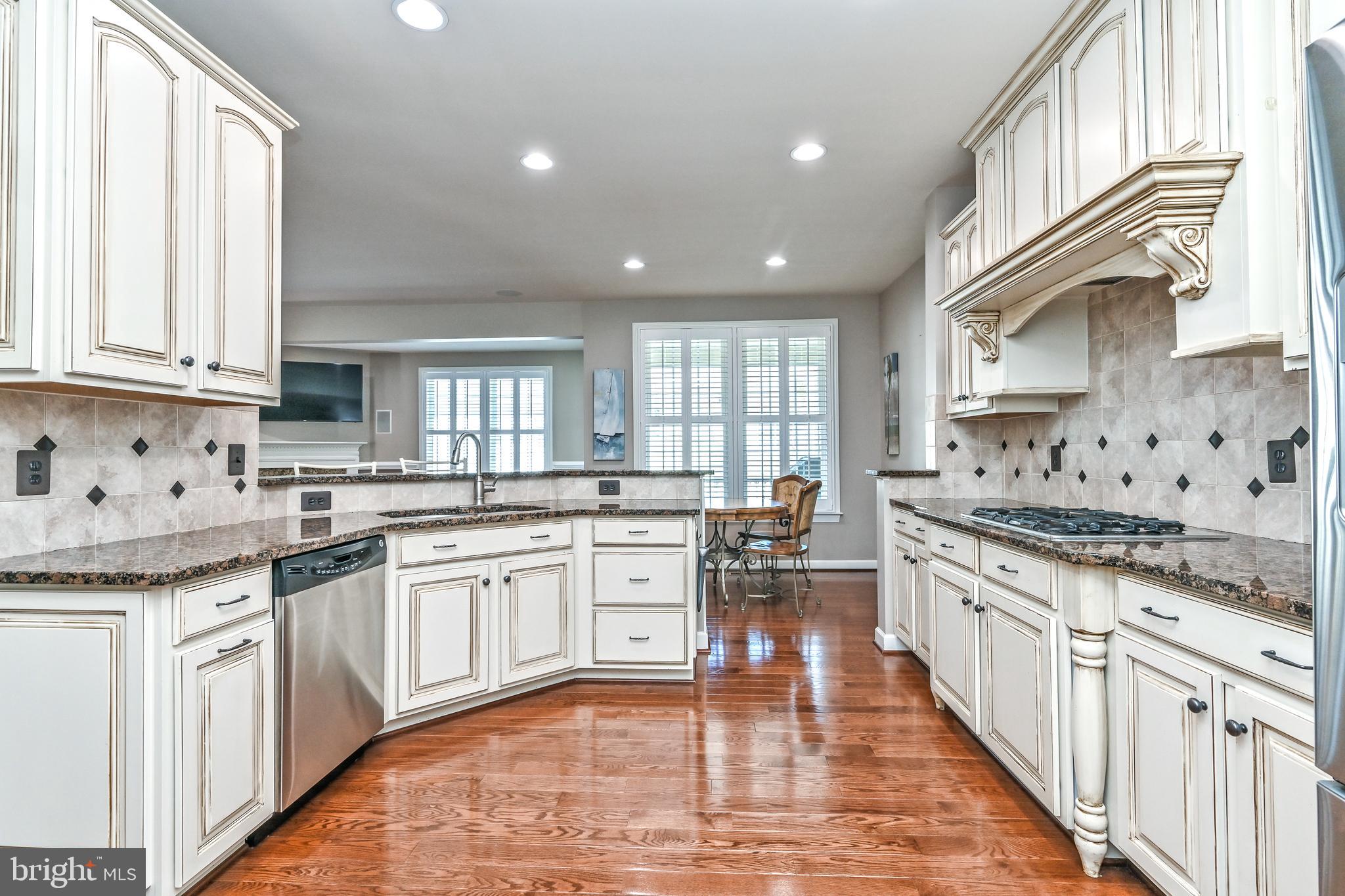 24947 Earlsford Drive Chantilly, VA 20152 - Photo 23 of 40 a kitchen with stainless steel appliances granite countertop a stove a sink dishwasher and a refrigerator