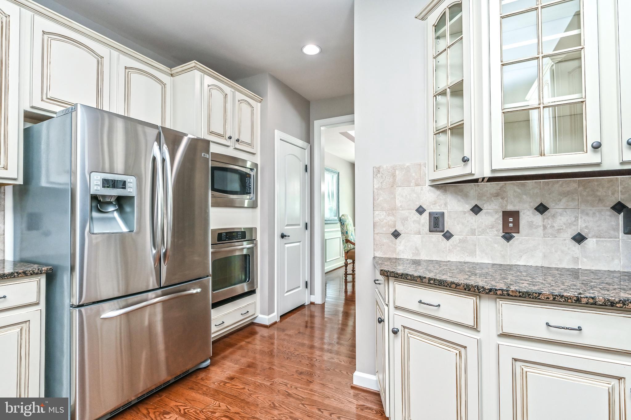 24947 Earlsford Drive Chantilly, VA 20152 - Photo 24 of 40 a kitchen with stainless steel appliances granite countertop a refrigerator and a sink