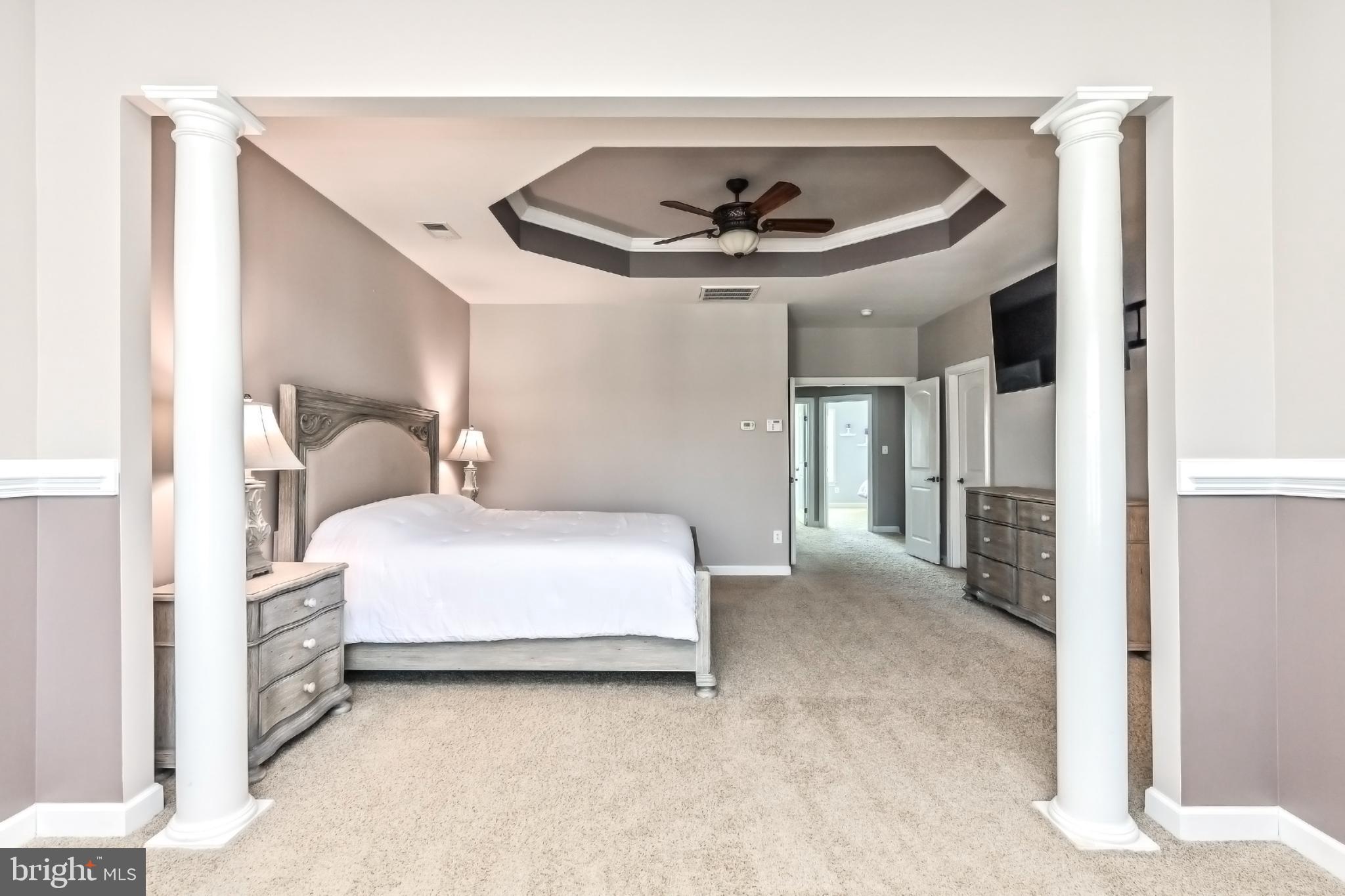 24947 Earlsford Drive Chantilly, VA 20152 - Photo 35 of 40 a bedroom with a bed and a chandelier