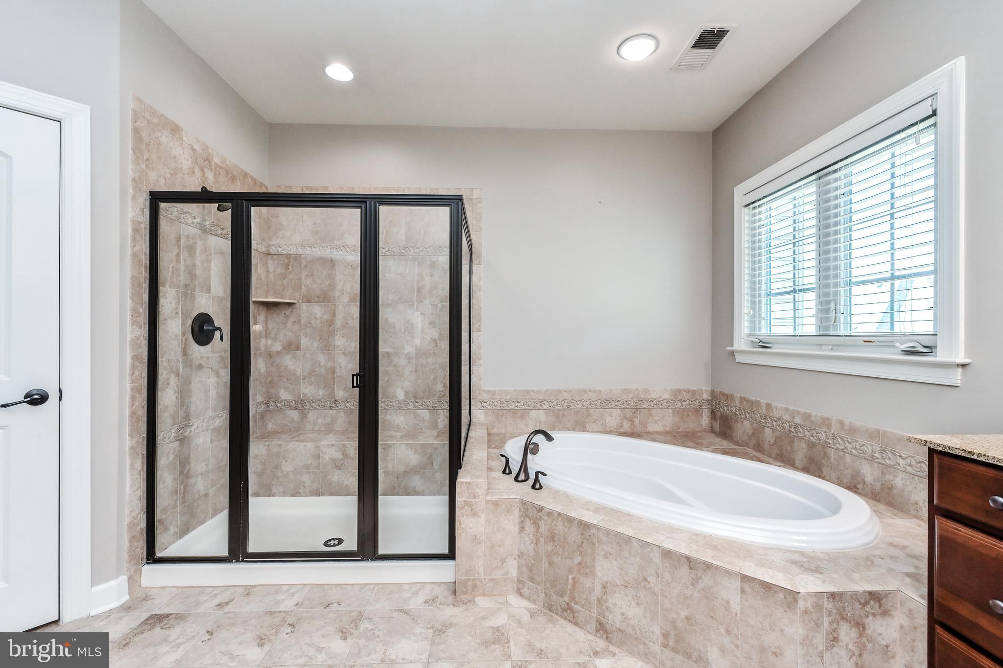 24947 Earlsford Drive Chantilly, VA 20152 - Photo 39 of 40 a bathroom with a bathtub and a shower