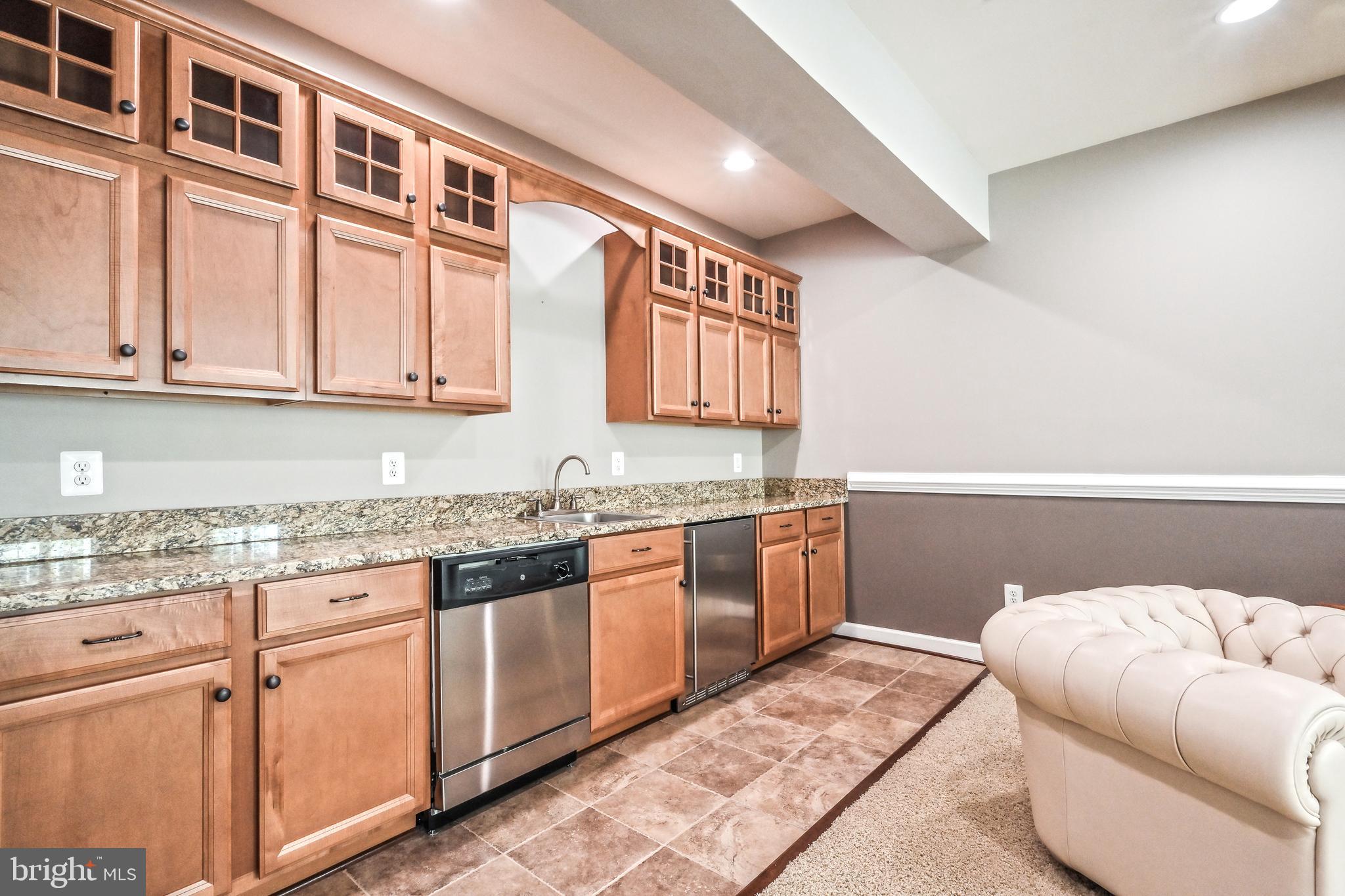 24947 Earlsford Drive Chantilly, VA 20152 - Photo 7 of 40 a kitchen with stainless steel appliances granite countertop a sink and cabinets