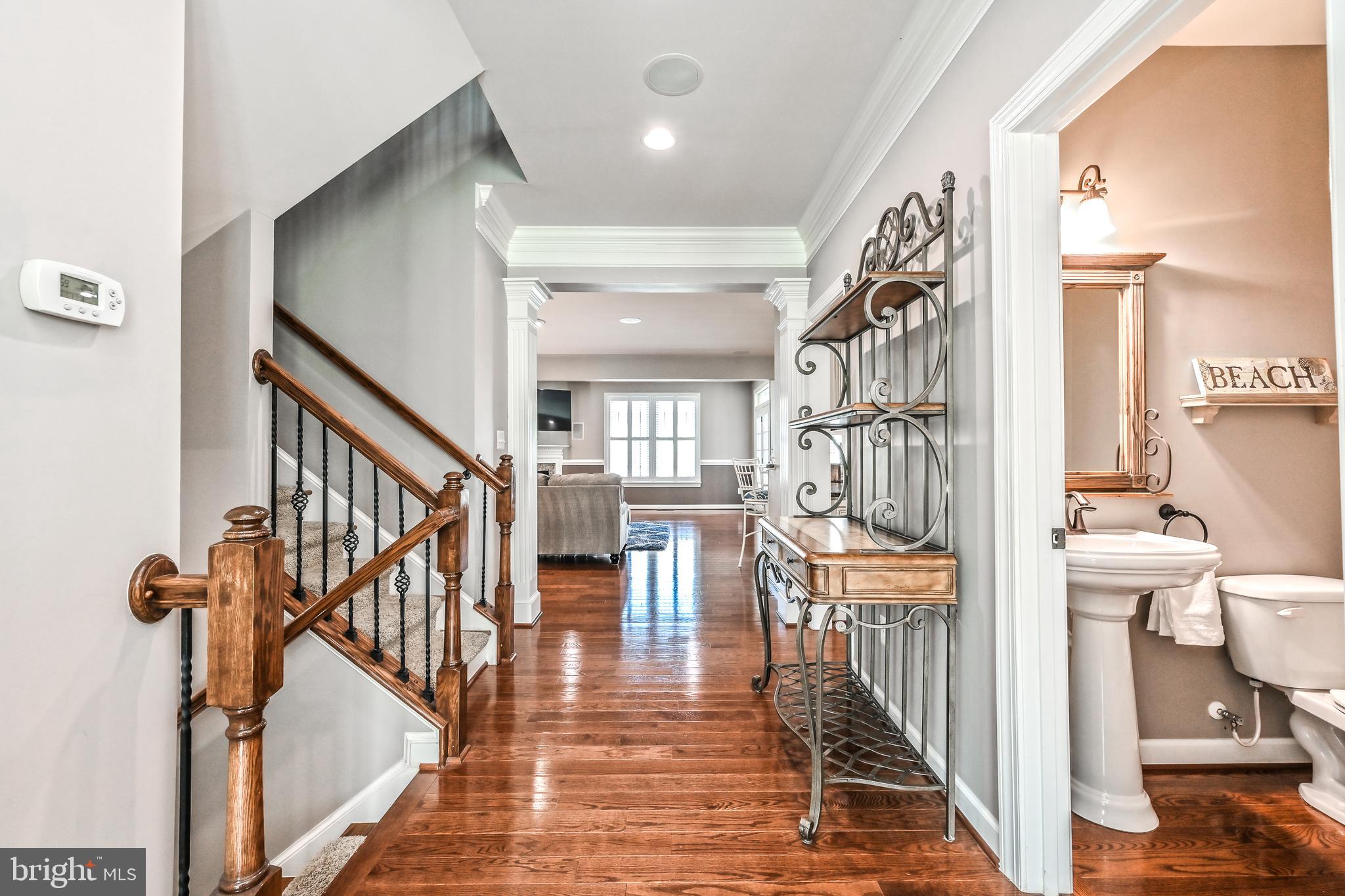 24947 Earlsford Drive Chantilly, VA 20152 - Photo 10 of 40 a view of a hallway with wooden floor and staircase