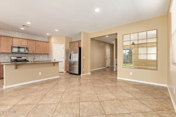 a view of a kitchen with an empty space and window