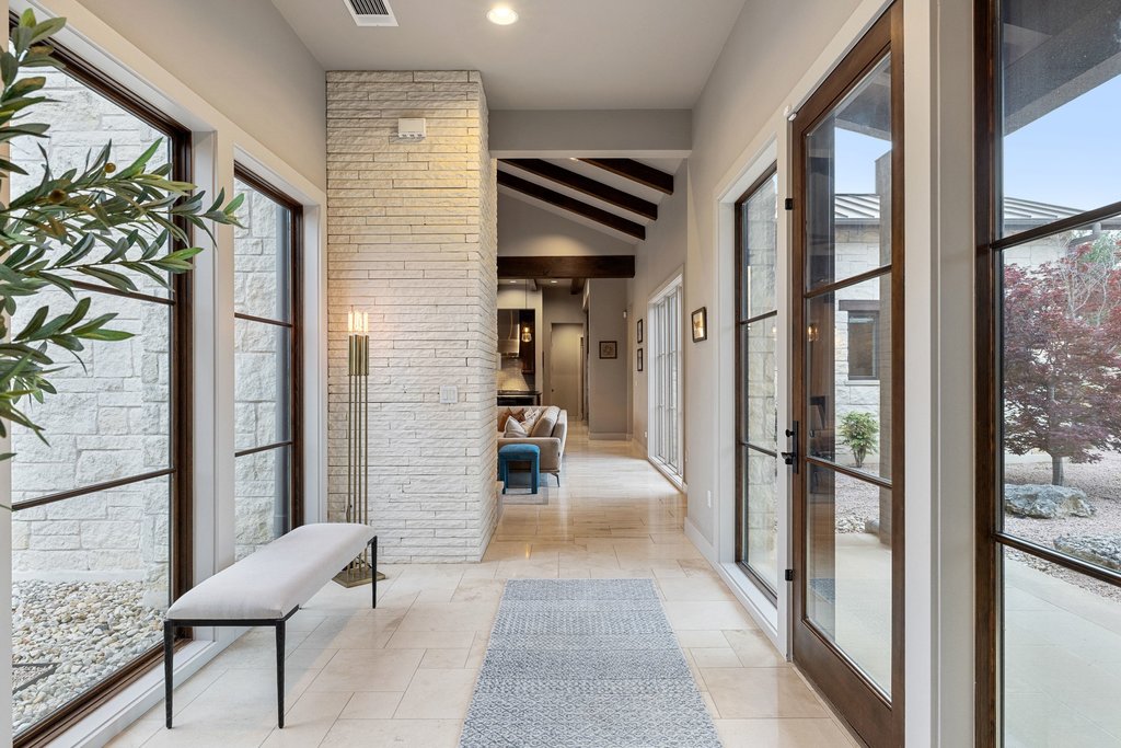 2560 Bell Springs Road Dripping Springs, TX 78620 - Photo 12 of 40 a view of a hallway with couch and windows